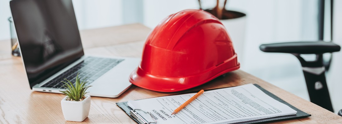 Un ordinateur, un casque, et un document officiel posés sur la table